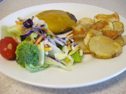 Cheeseburger, potatoes and salad